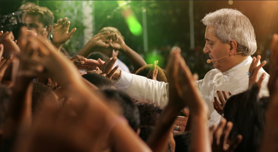 Pastor Benny Hinn laying hands on people