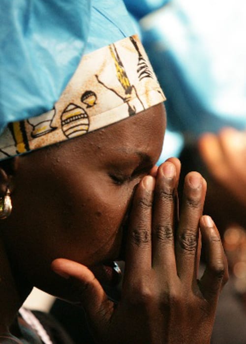 African lady worshiping at Benny Hinn Ministries Event