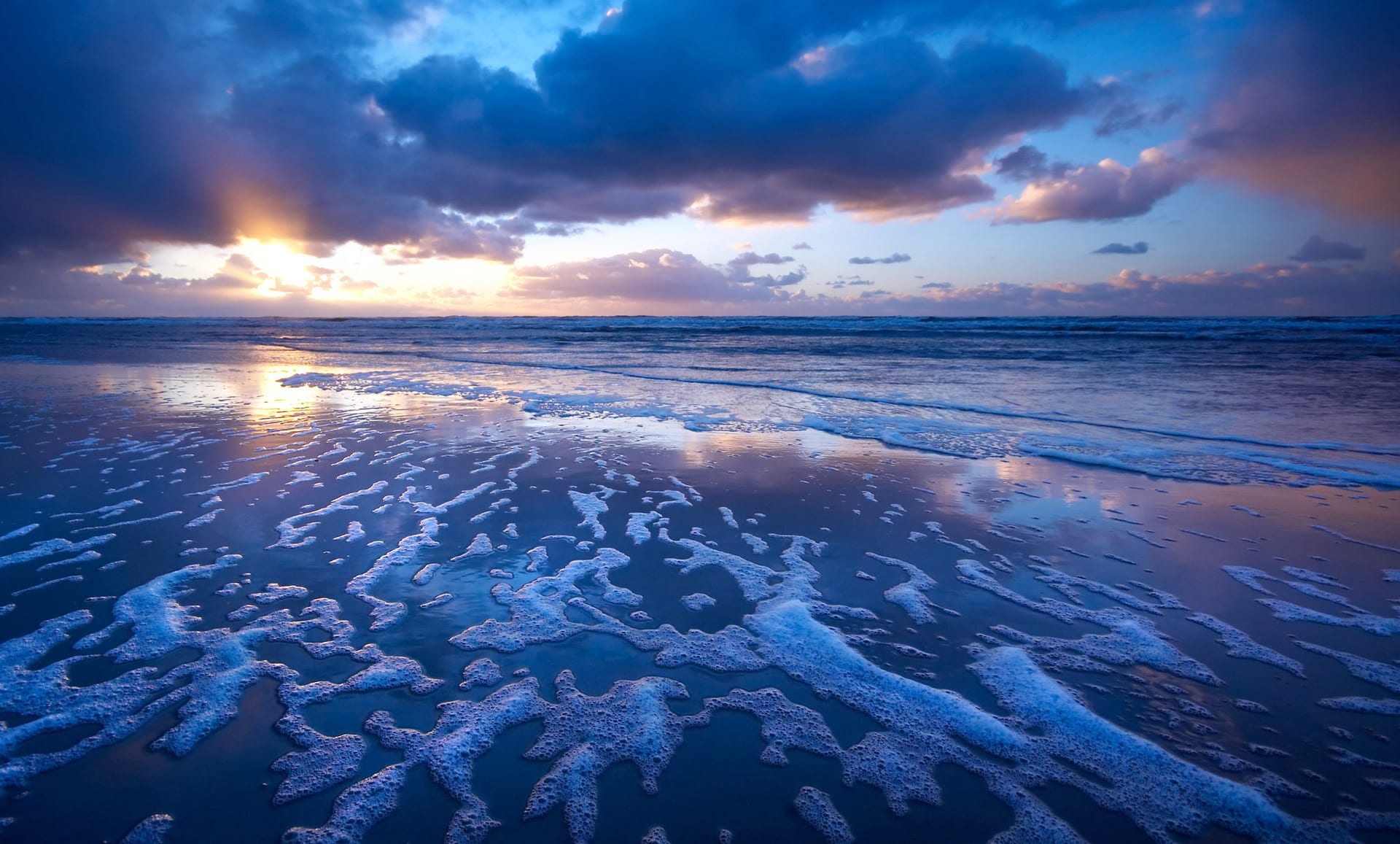 Sunrise over a cloudy beach