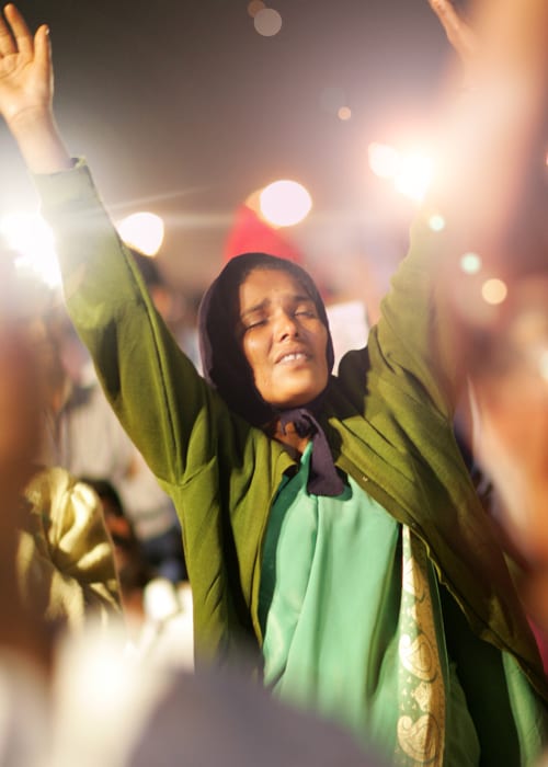 Woman in India prays at Benny Hinn Ministries Event