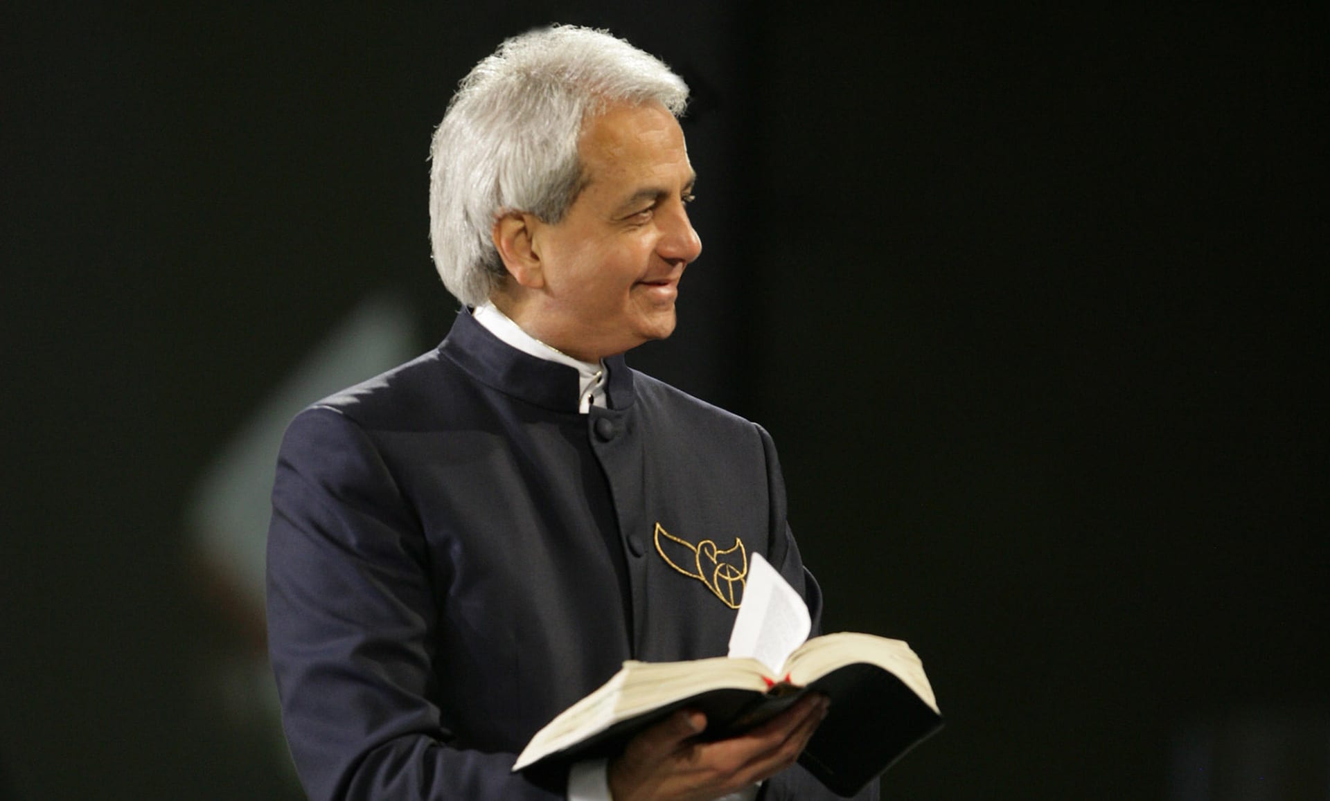 Benny Hinn smiling with Bible