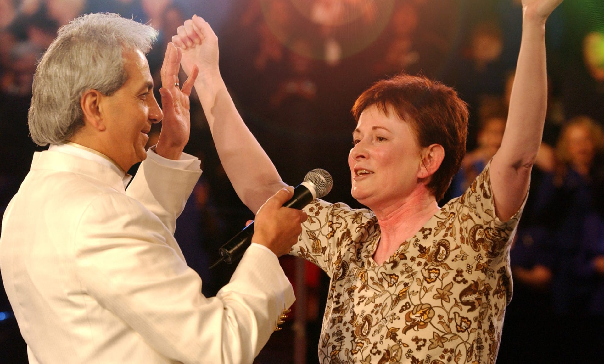 Woman healed raised arms eblast Benny Hinn Ministries Woman healed raised arms